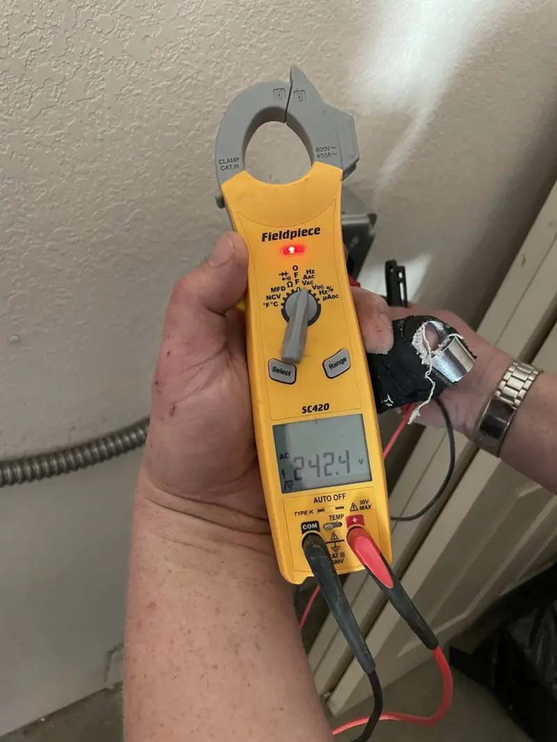 Voltage testing with clamp meter during Ceiling Fan Installation in University Heights